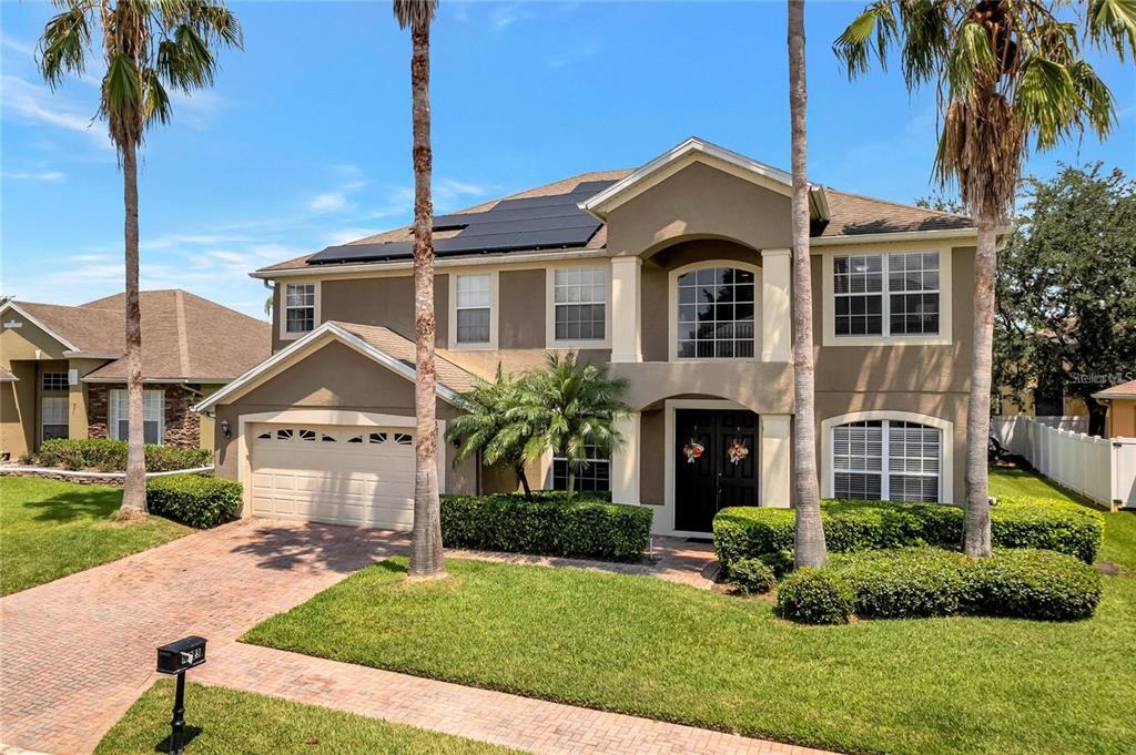 10023 Ians Ridge Road Orlando, FL 32832 - Photo 2 of 60 a front view of a house with a yard and garage
