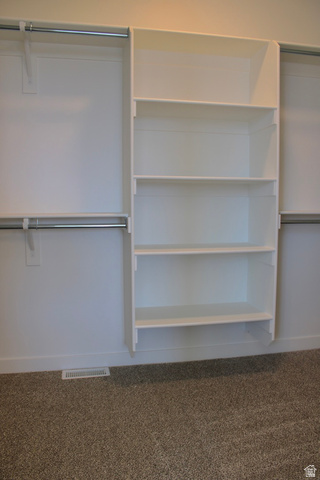 2613 Scarlet Road, Unit 258 Eagle Mountain, UT 84005 - Photo 18 of 32 Built-in white shelving system with four shelves, complemented by two chrome hanging rods on either side