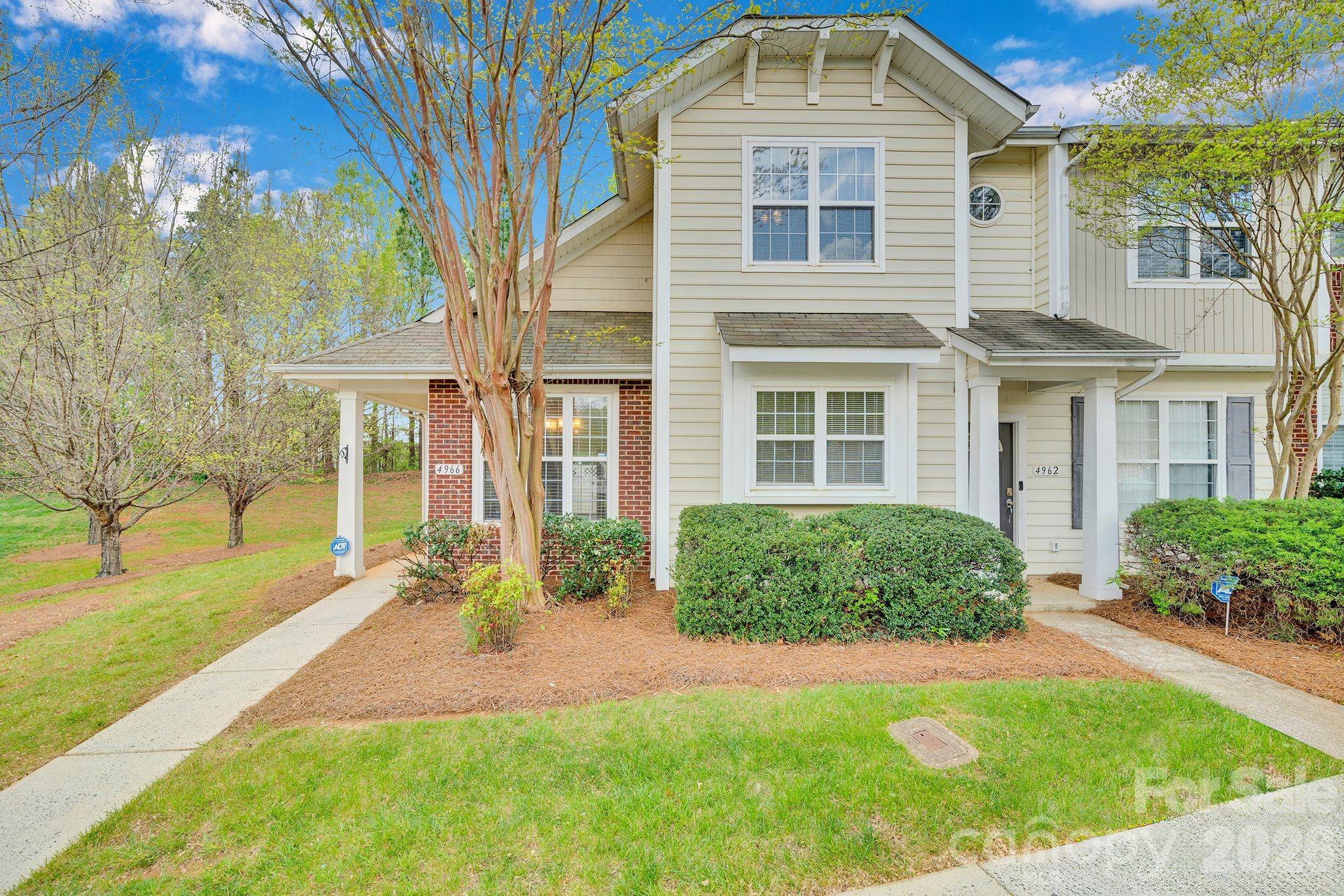 4966 Sunset Ridge Court Charlotte, NC 28269 - Photo 1 of 42 a front view of a house with a yard