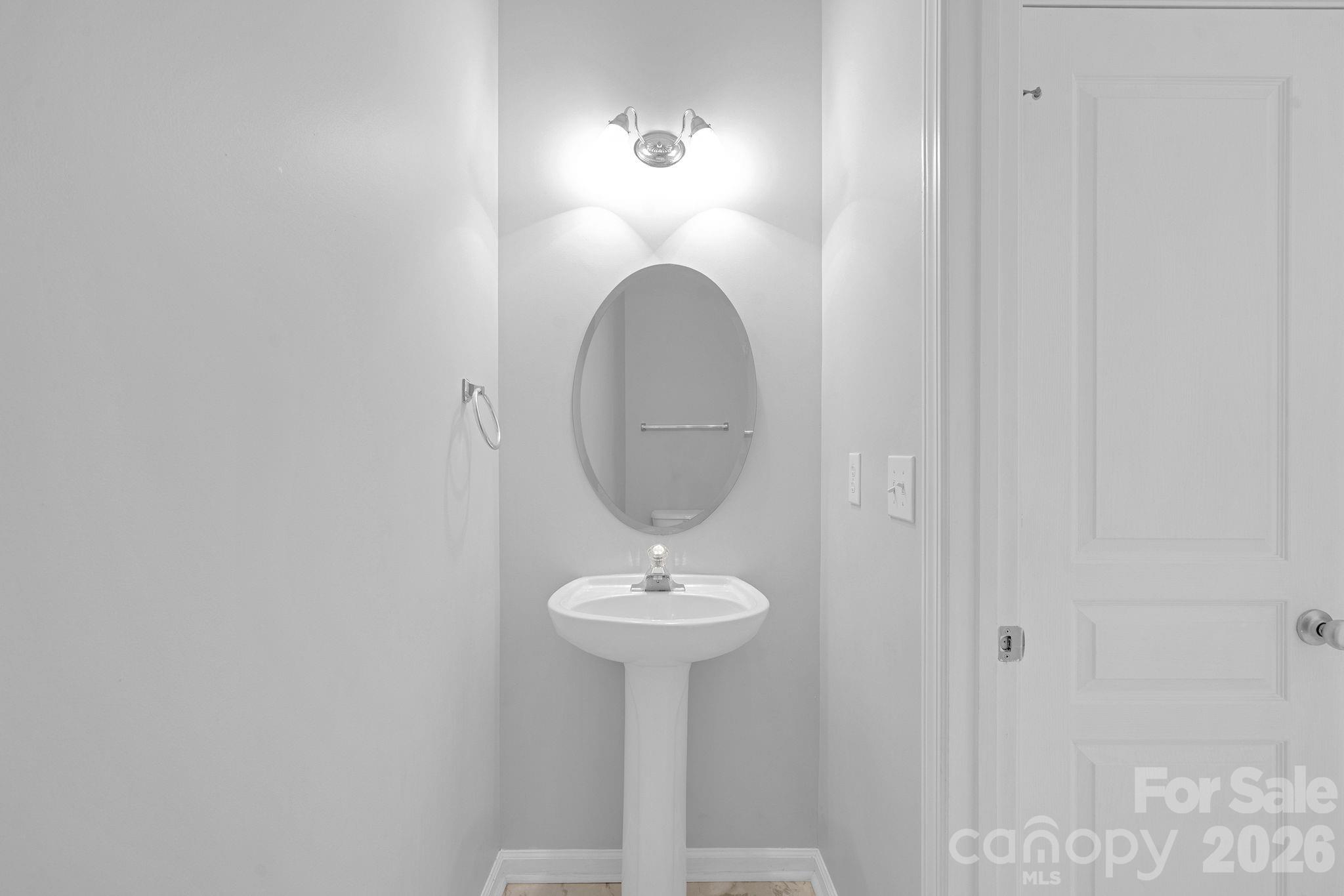 4966 Sunset Ridge Court Charlotte, NC 28269 - Photo 16 of 42 a bathroom with a sink and a mirror