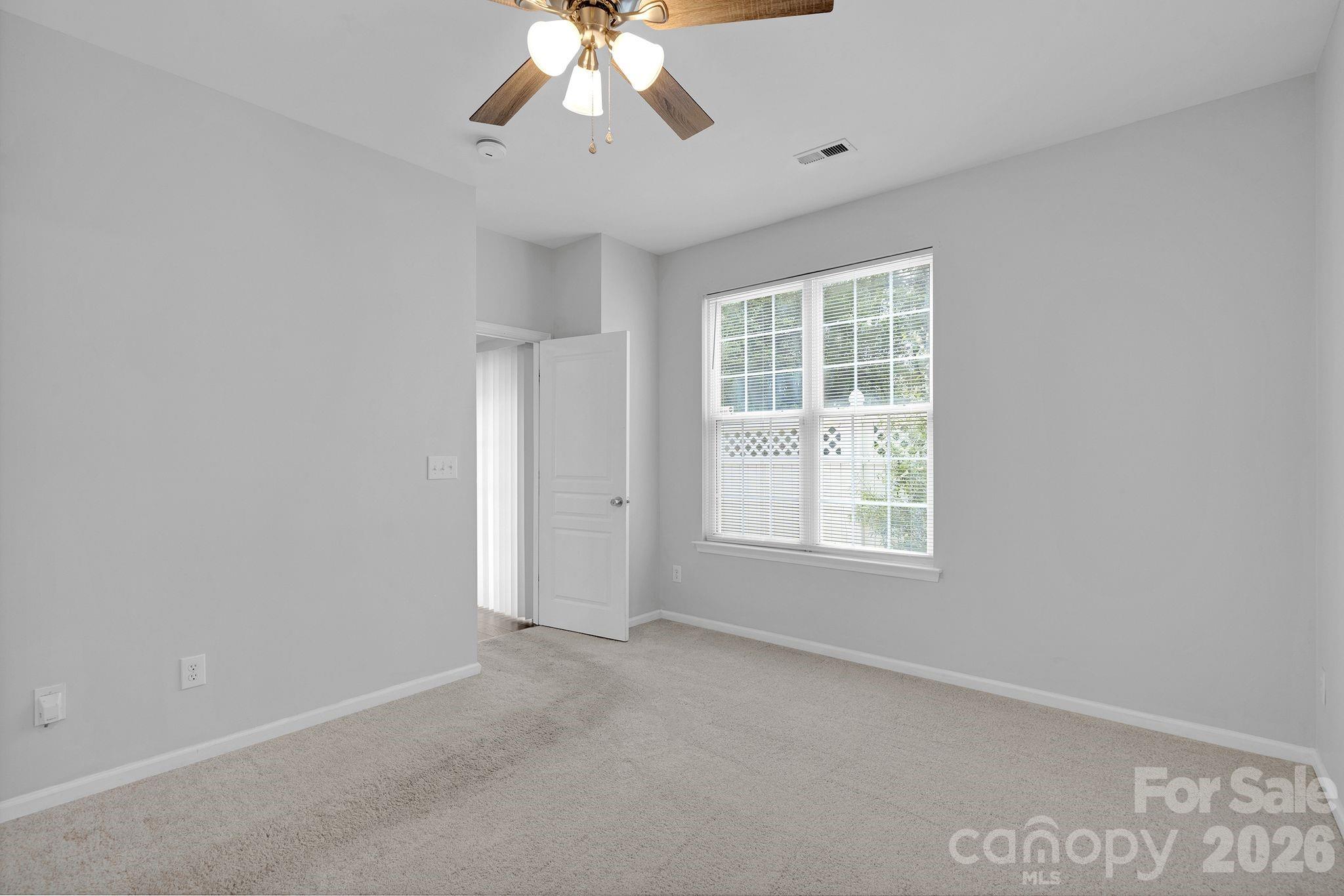 4966 Sunset Ridge Court Charlotte, NC 28269 - Photo 19 of 42 a view of an empty room with a window