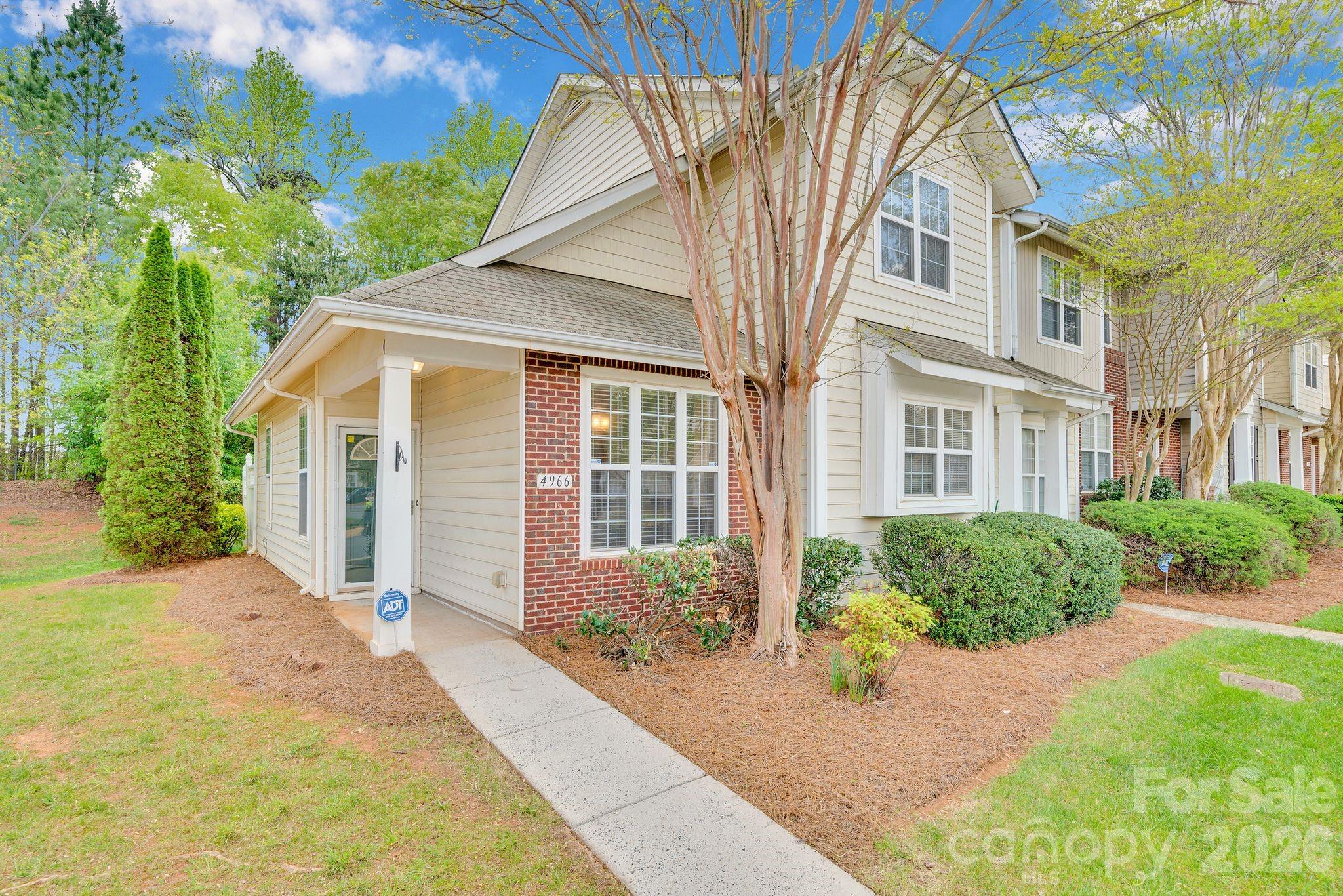4966 Sunset Ridge Court Charlotte, NC 28269 - Photo 2 of 42 a front view of a house with a yard