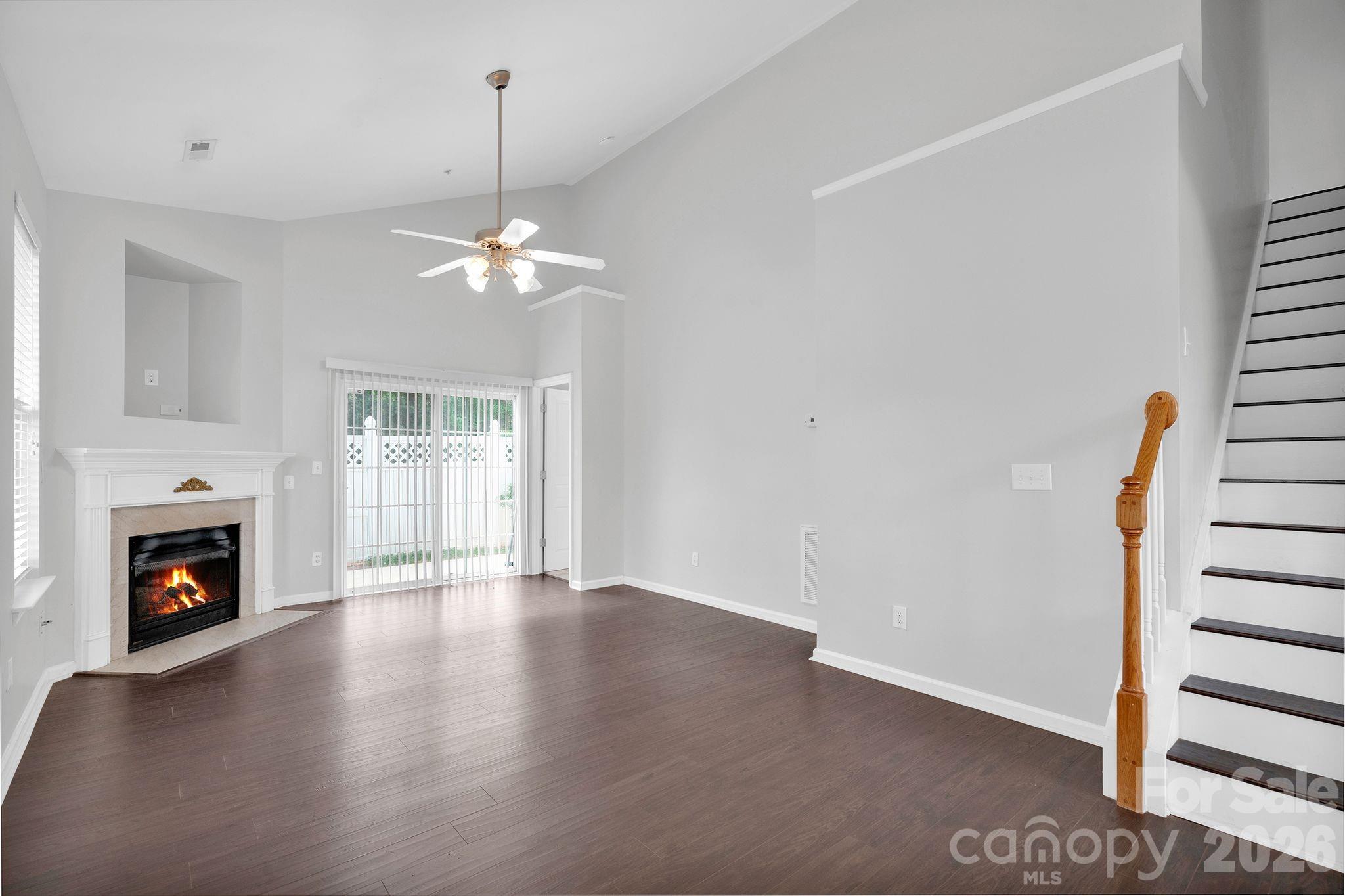 4966 Sunset Ridge Court Charlotte, NC 28269 - Photo 4 of 42 a view of an empty room with wooden floor fireplace and a window