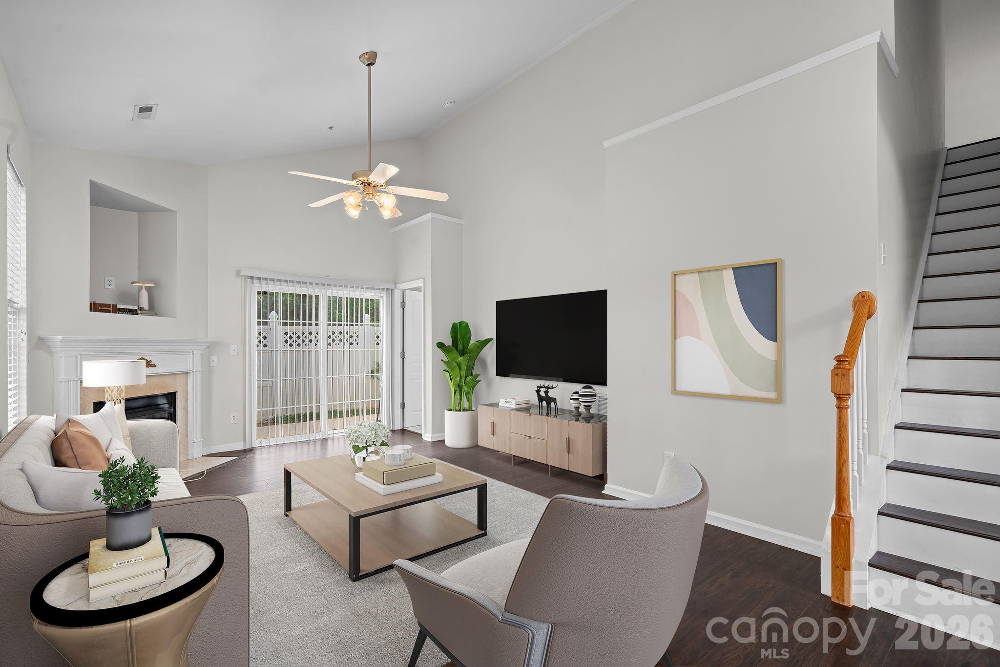 4966 Sunset Ridge Court Charlotte, NC 28269 - Photo 5 of 42 a living room with furniture a fireplace and a flat screen tv