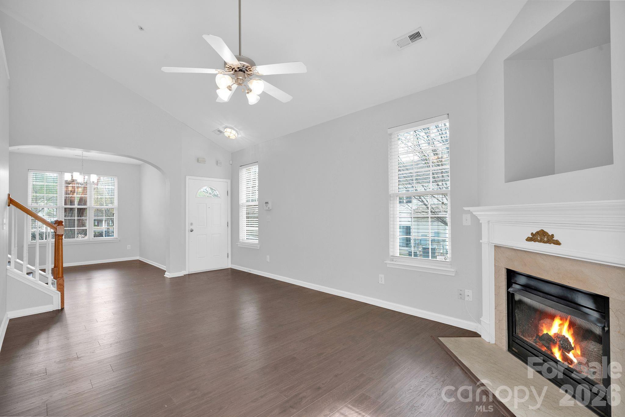 4966 Sunset Ridge Court Charlotte, NC 28269 - Photo 7 of 42 a view of an empty room with wooden floor fireplace and a window