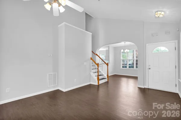 a dining room with furniture a rug and wooden floor