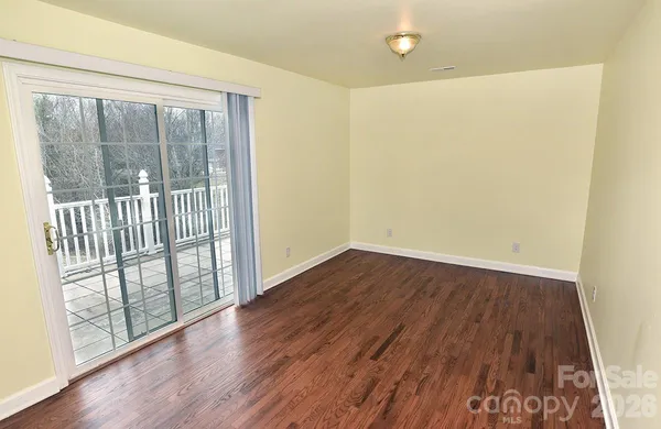 a view of a room with wooden floor and a window