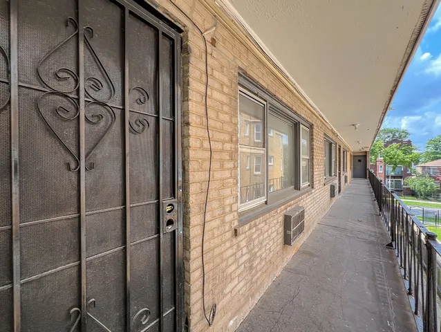 a view of a porch with wooden floor and windows