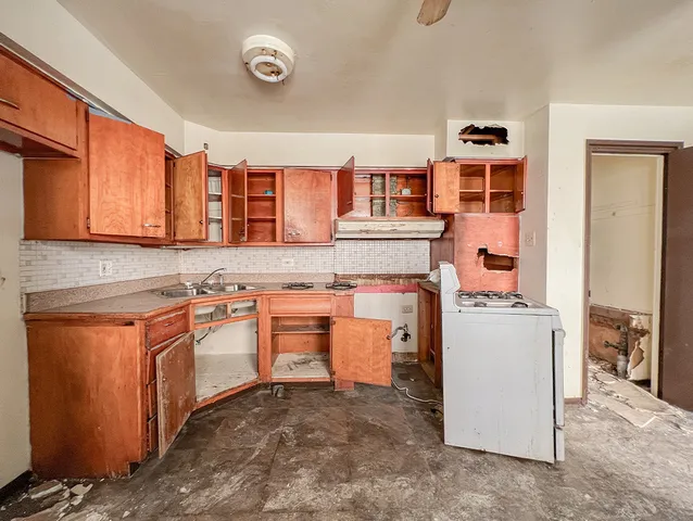 a kitchen with stainless steel appliances granite countertop a stove and a sink