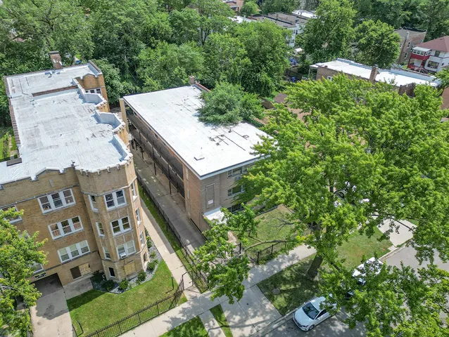 an aerial view of a house with a yard basket ball court and outdoor seating