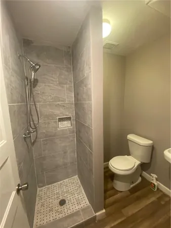 a bathroom with a toilet and a shower
