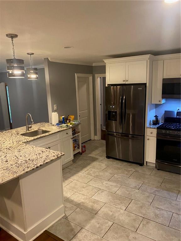 336 Simpson Terrace Northwest Atlanta, GA 30314 - Photo 6 of 15 a kitchen with stainless steel appliances granite countertop a refrigerator and a sink