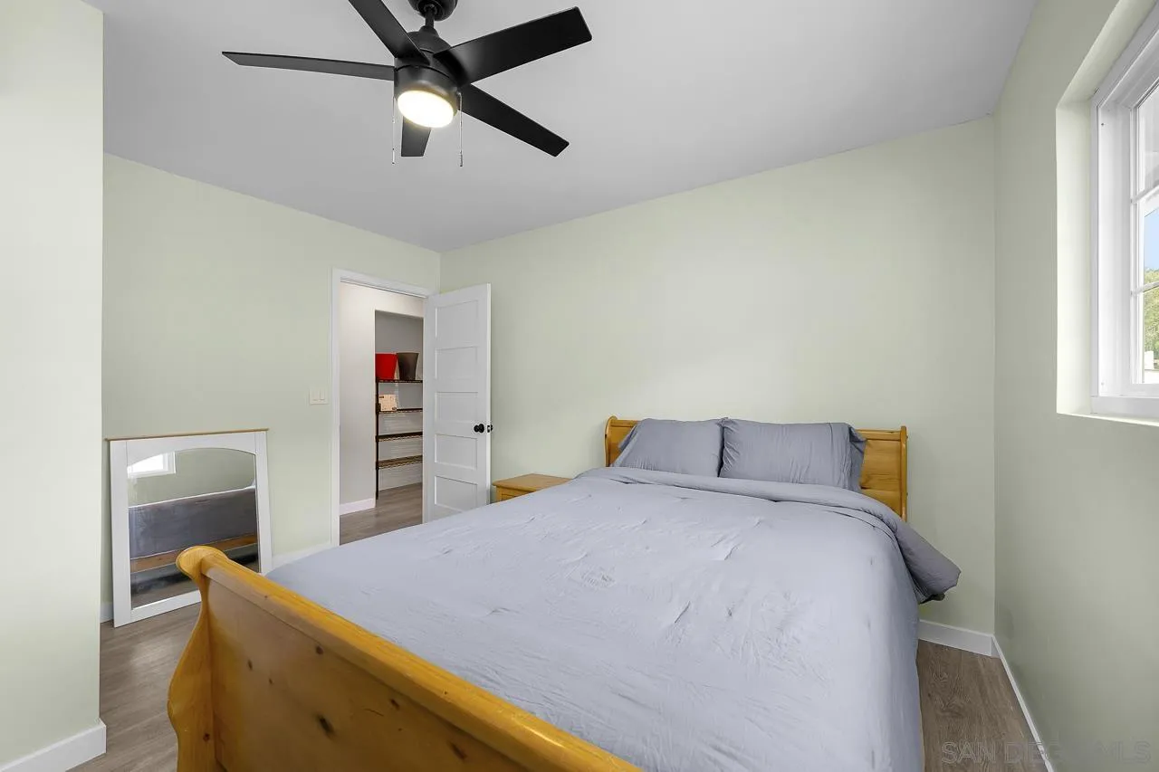 3232 Monterey Crest Drive Jamul, CA 91935 - Photo 14 of 52 a bed room with a bed and a chandelier