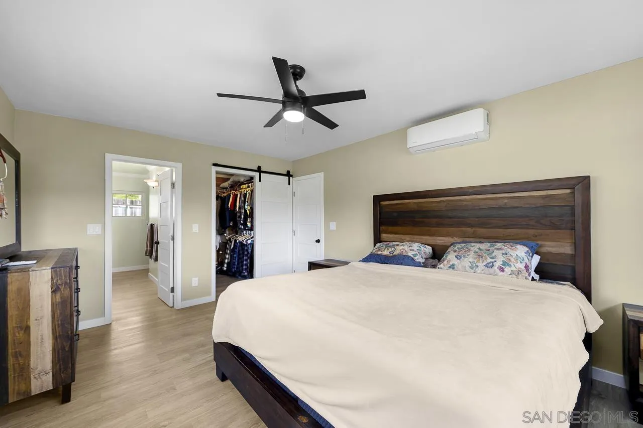 3232 Monterey Crest Drive Jamul, CA 91935 - Photo 20 of 52 a bedroom with a bed and a chandelier