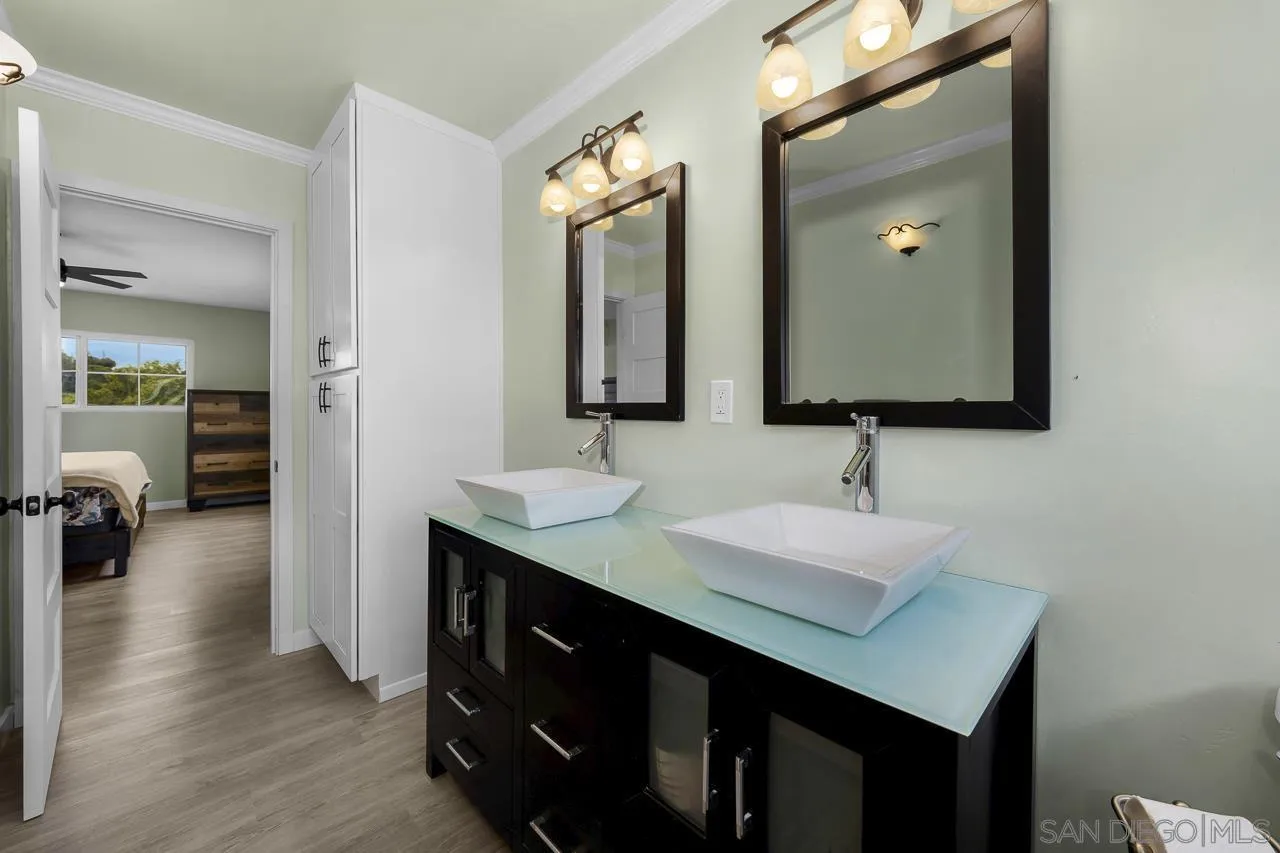 3232 Monterey Crest Drive Jamul, CA 91935 - Photo 23 of 52 a bathroom with a sink double vanity and a mirror