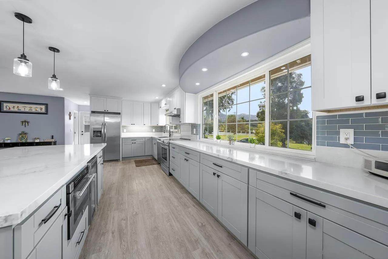 3232 Monterey Crest Drive Jamul, CA 91935 - Photo 26 of 52 a large kitchen with granite countertop a large counter top appliances and cabinets