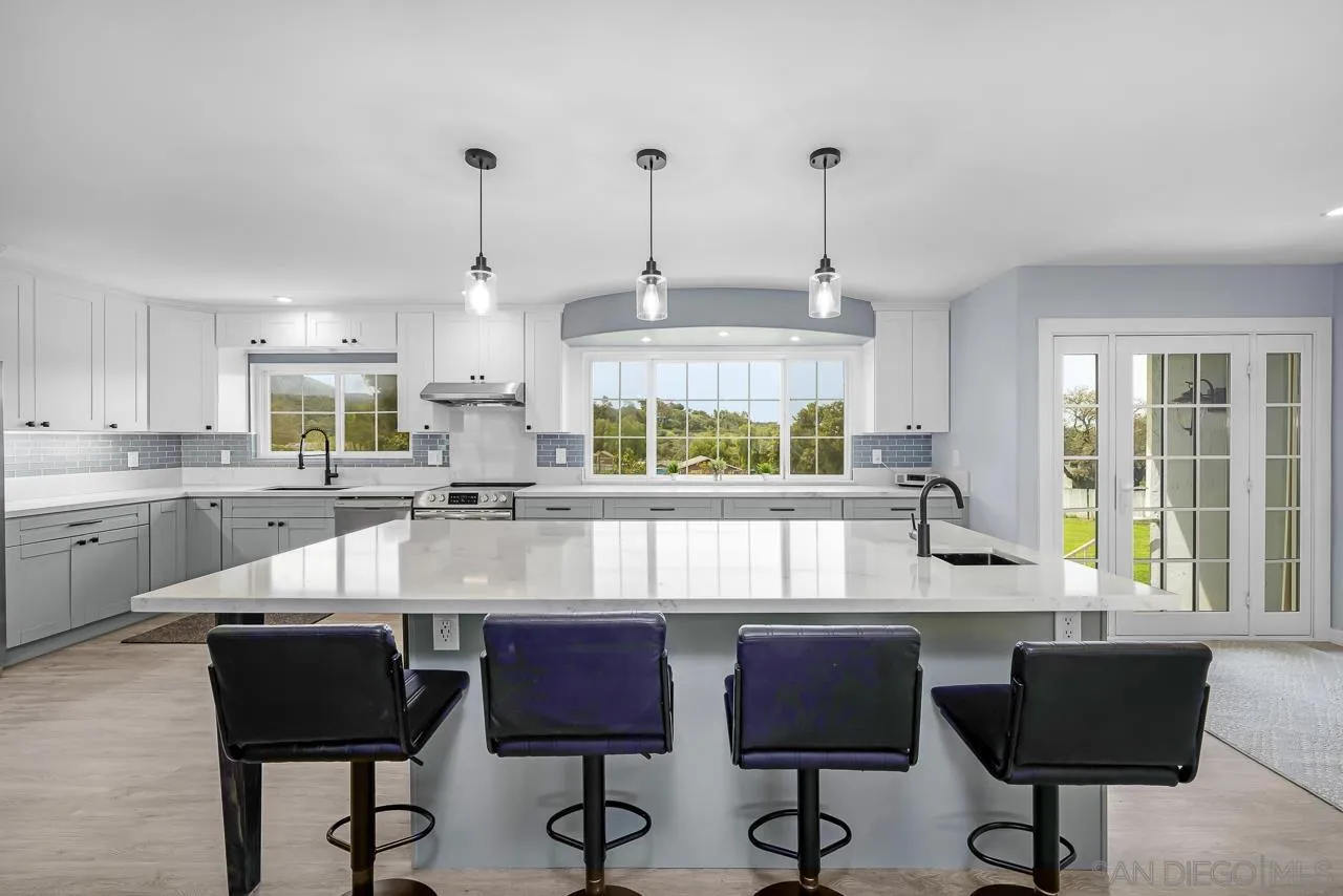 3232 Monterey Crest Drive Jamul, CA 91935 - Photo 27 of 52 a kitchen with stainless steel appliances granite countertop a stove a sink a counter top space and cabinets