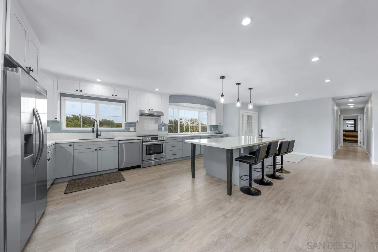 3232 Monterey Crest Drive Jamul, CA 91935 - Photo 34 of 52 a kitchen with a sink cabinets and wooden floor