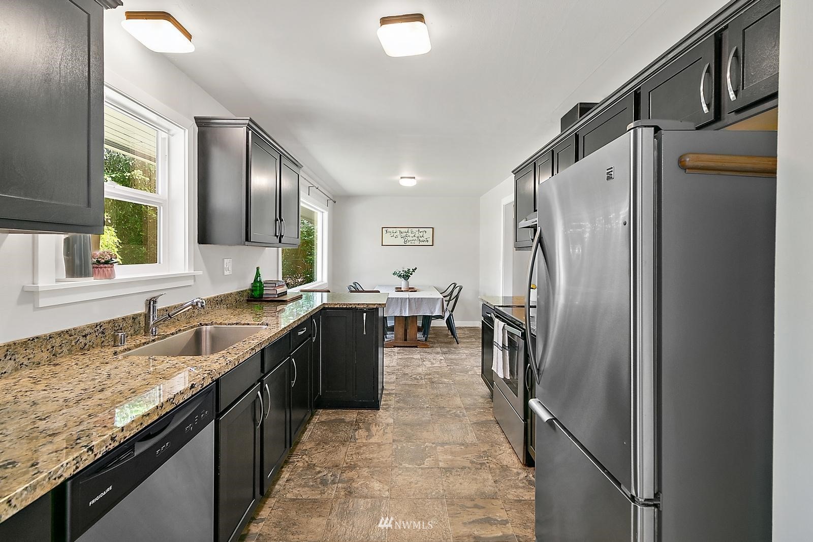 2802 South 304th Street Federal Way, WA 98003 - Photo 11 of 24 a kitchen with granite countertop a refrigerator and a sink