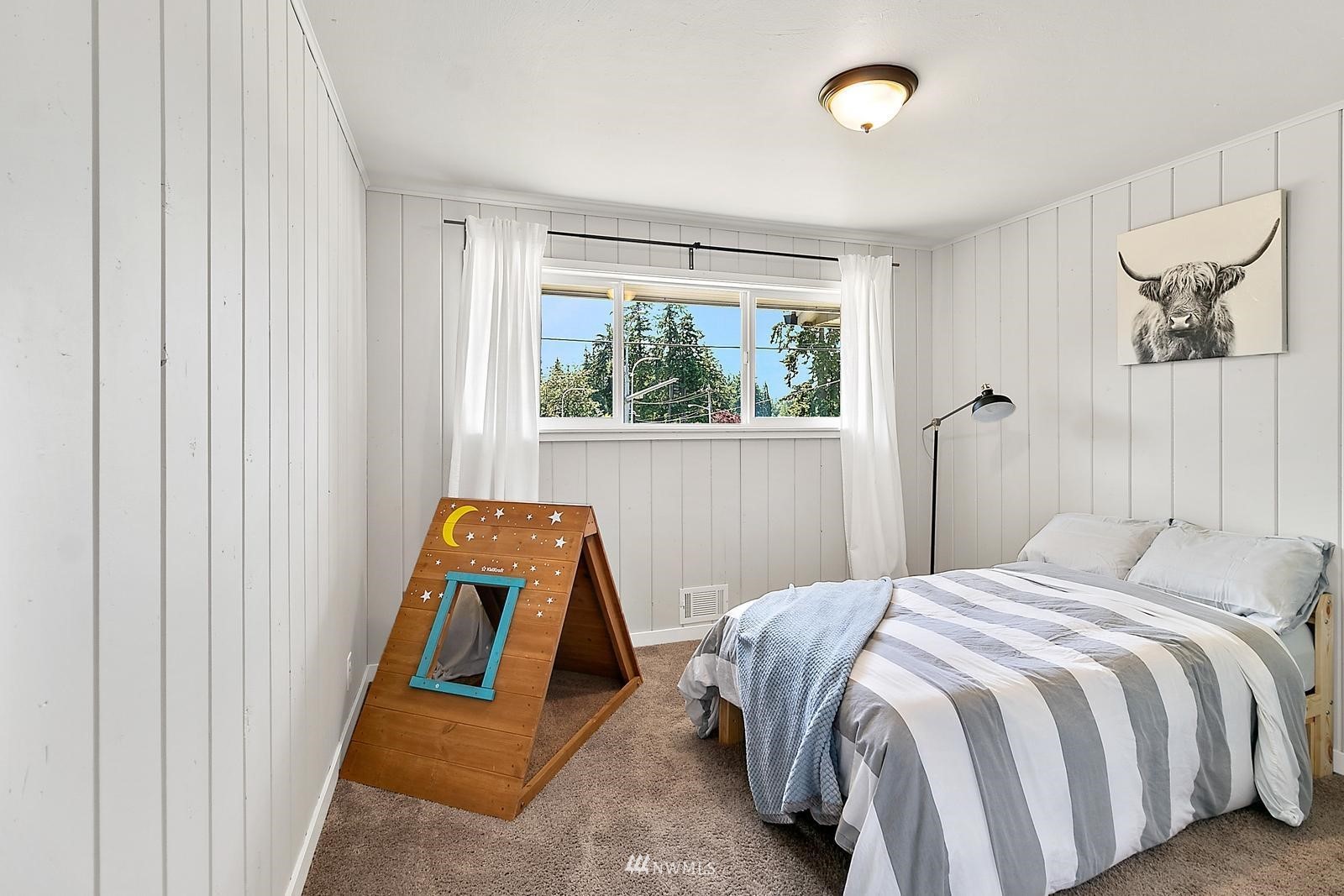 2802 South 304th Street Federal Way, WA 98003 - Photo 15 of 24 a bed sitting in a bedroom next to a window