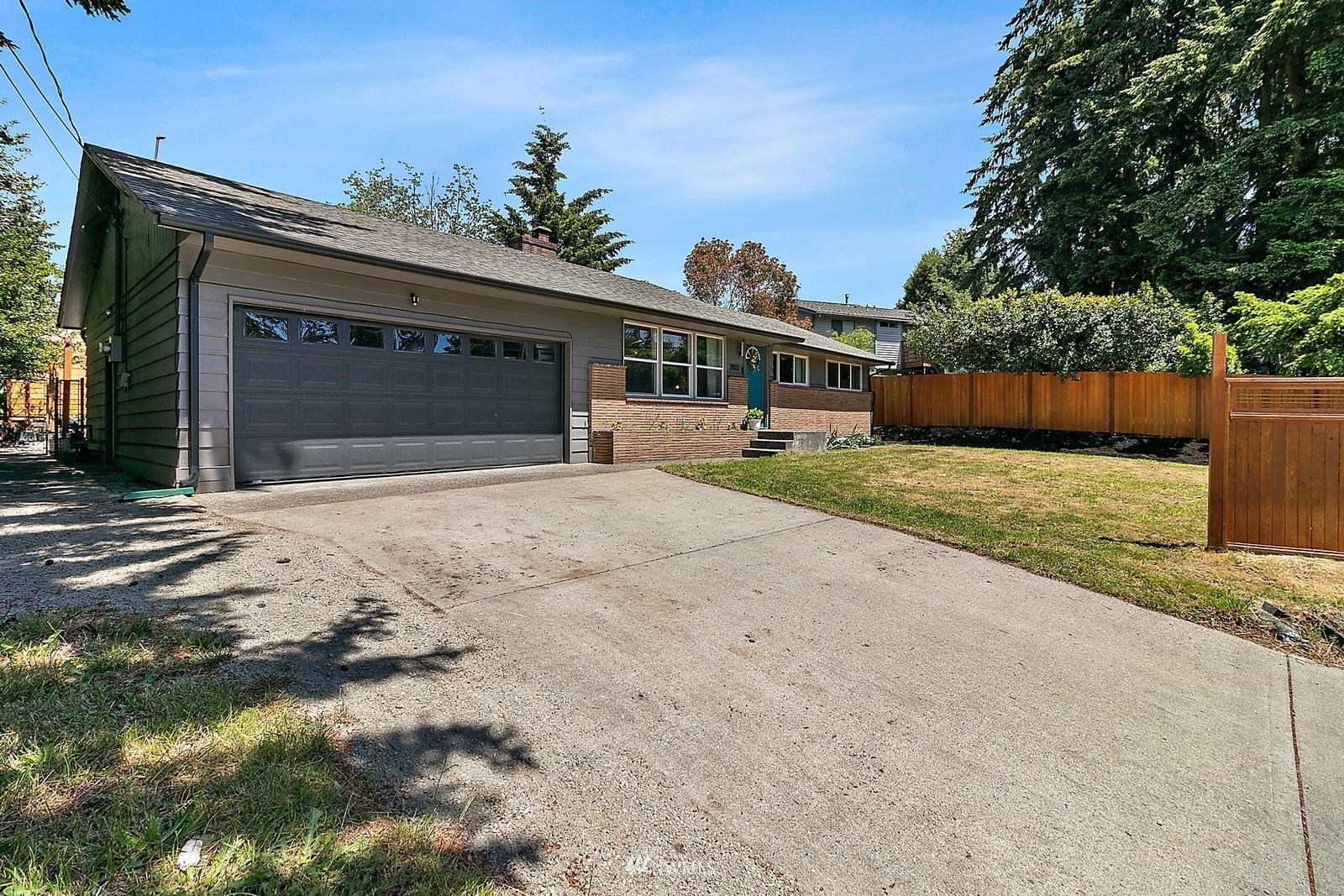 2802 South 304th Street Federal Way, WA 98003 - Photo 22 of 24 a front view of a house with a yard and garage