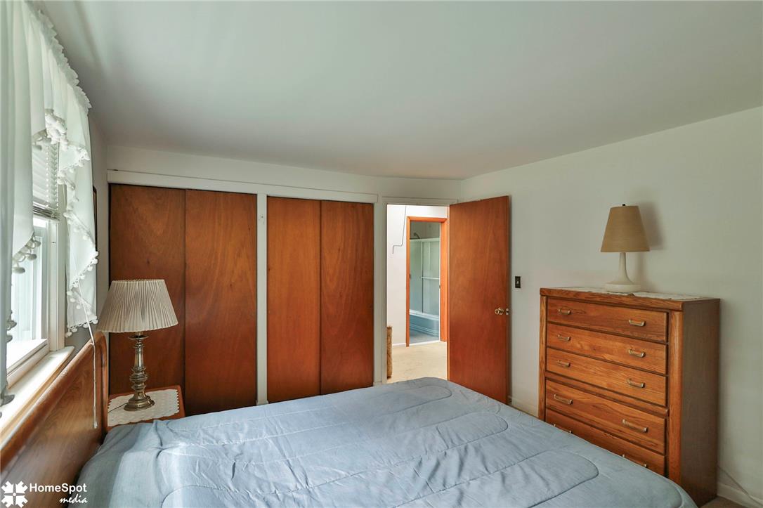 6054 Old Hickory Road Coopersburg, PA 18036 - Photo 36 of 48 Rich wood doors and natural light create a warm ambiance in this comfortable bedroom.