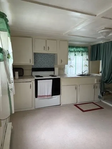 a kitchen with stainless steel appliances a stove a sink and a refrigerator