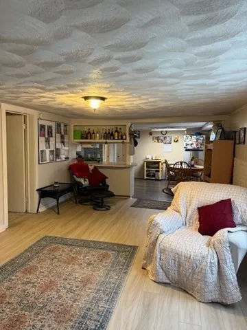 a bedroom with furniture and a wooden floor