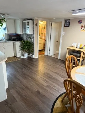 a view of a livingroom with furniture and hardwood floor