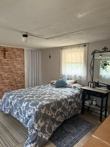 124 Hazen Road Shirley, MA 01464 - Photo 9 of 31 a bedroom with a bed and wooden floor