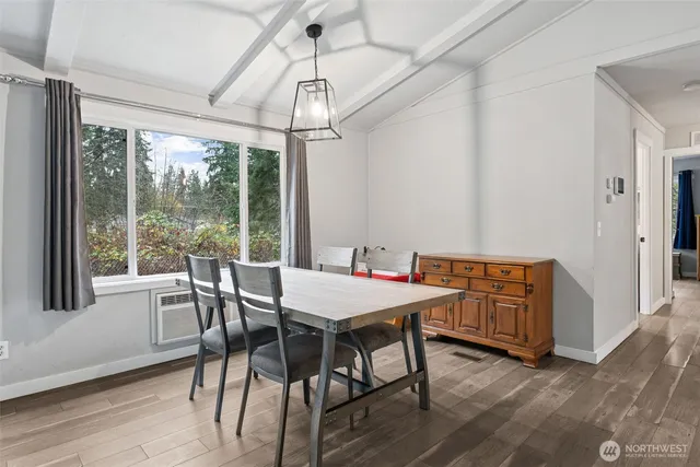 a view of a dining room with furniture wooden floor and chandelier