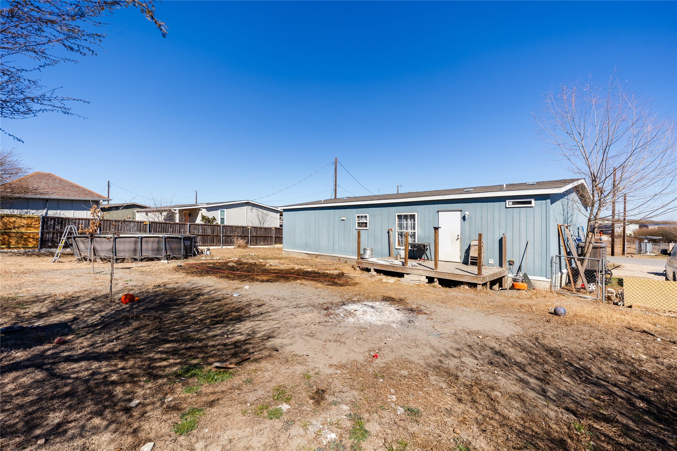 513 Duchess Pass Kyle, TX 78640 - Photo 14 of 16 a backyard of a house with table and chairs under an umbrella