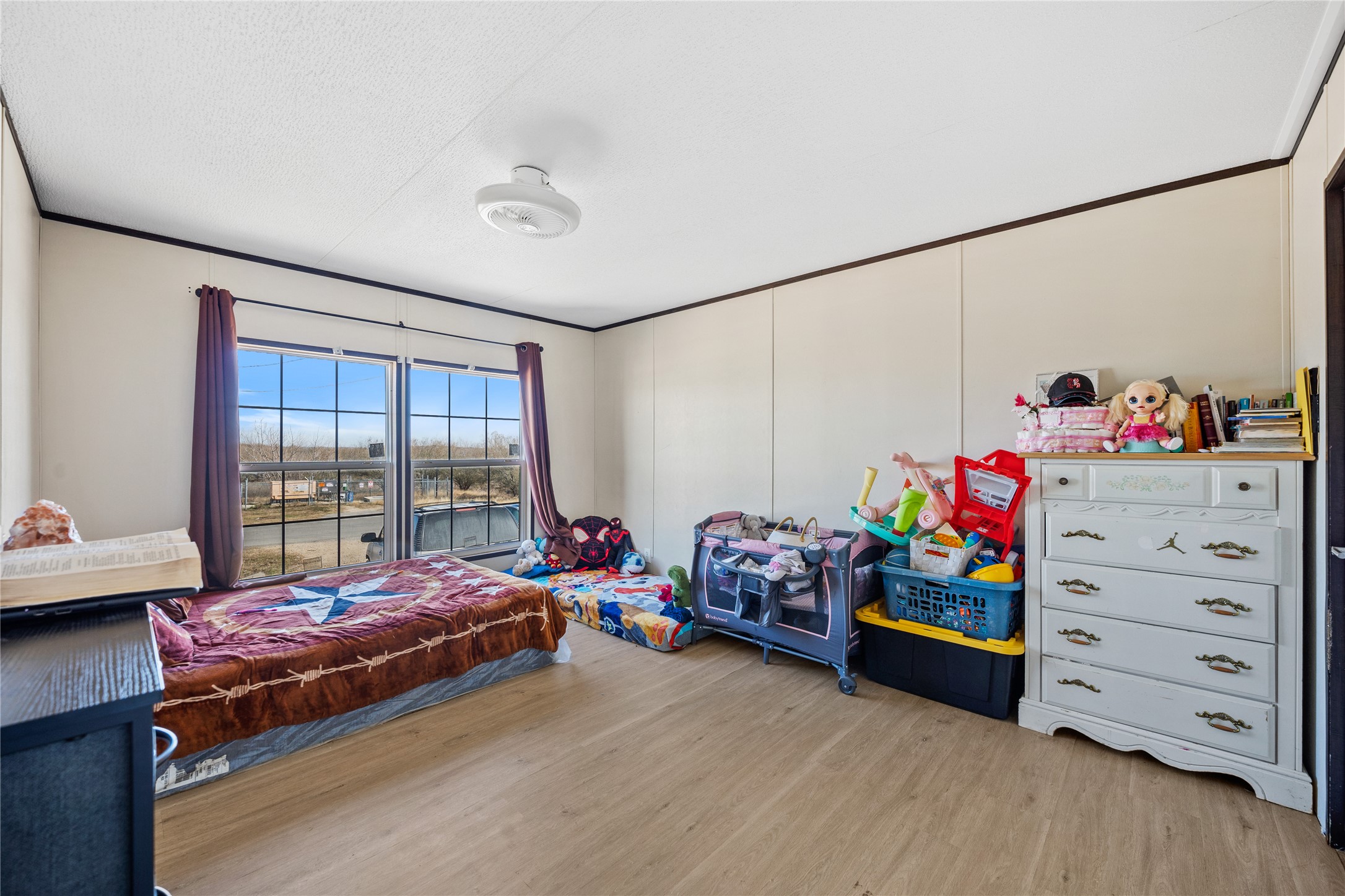513 Duchess Pass Kyle, TX 78640 - Photo 7 of 16 a bedroom with a bed and wooden floor