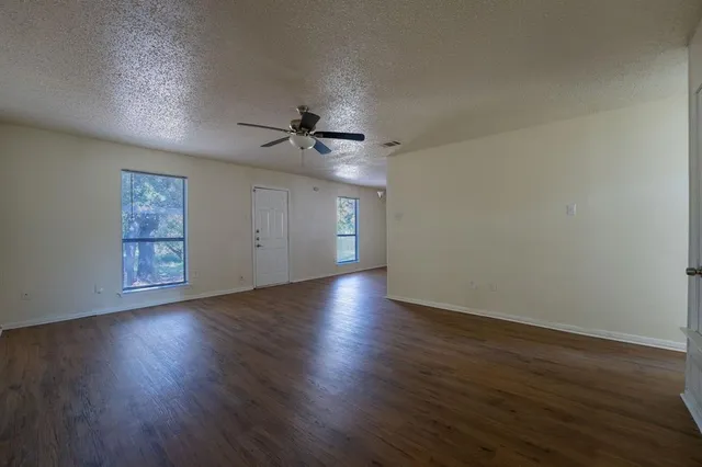 a view of wooden floor and windows in a room