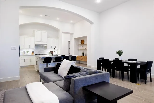 a living room with furniture a dining table and a potted plant