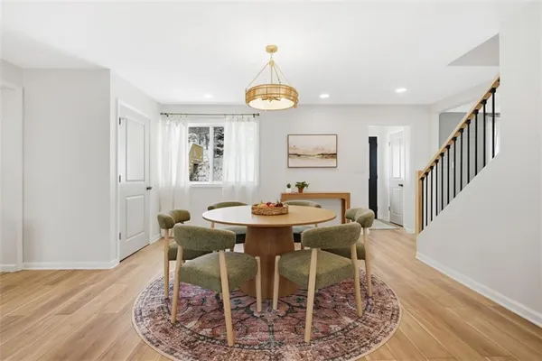 a view of a a dining room with furniture window and wooden floor