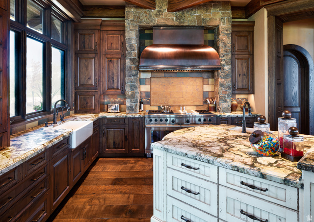 2322 North Westward Ho Road Heber City, UT 84036 - Photo 10 of 54 Kitchen featuring two tone color scheme, light stone counters, dark wood-style flooring, range with two ovens, and ventilation hood