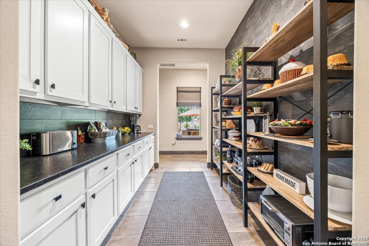 742 Pacific Spring Branch, TX 78070 - Photo 13 of 52 a kitchen with stainless steel appliances granite countertop a lot of cabinets and wooden floor