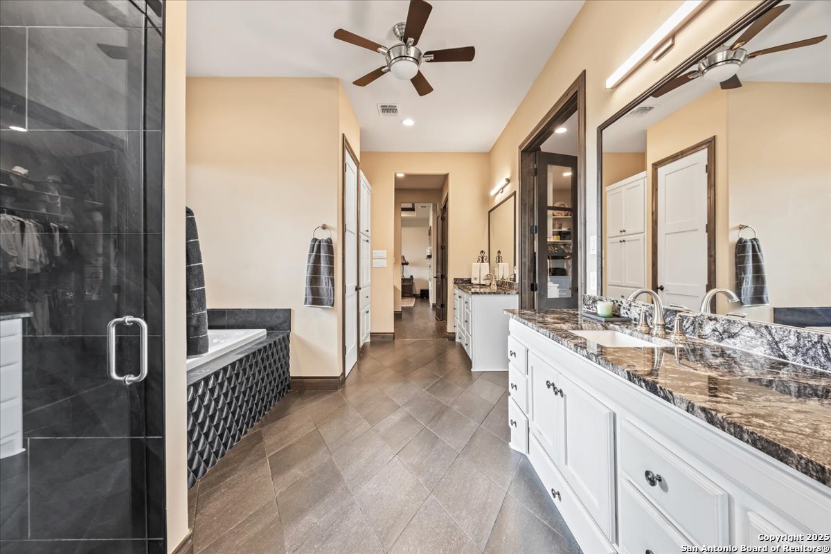 742 Pacific Spring Branch, TX 78070 - Photo 20 of 52 a large white kitchen with a large window and stainless steel appliances