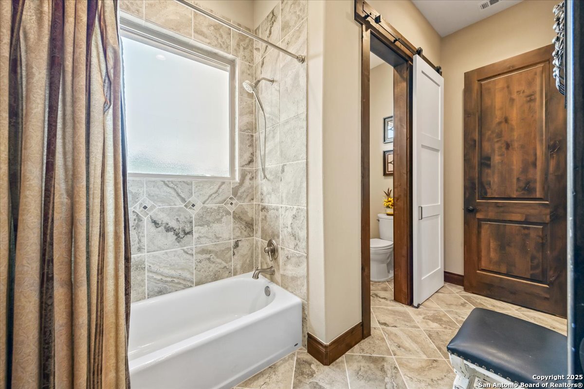742 Pacific Spring Branch, TX 78070 - Photo 27 of 52 a bathroom with a bathtub and a shower