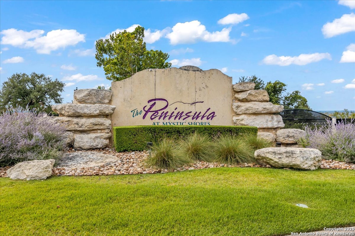 742 Pacific Spring Branch, TX 78070 - Photo 4 of 52 a sign that is sitting in the grass with plants and wooden fence
