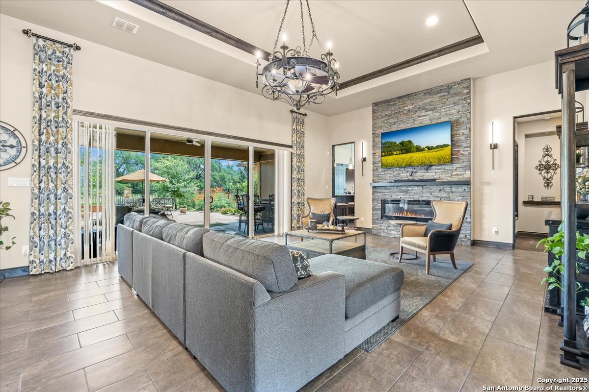 742 Pacific Spring Branch, TX 78070 - Photo 7 of 52 a living room with fireplace furniture and a chandelier