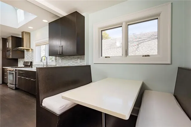 a kitchen with a table chairs sink and cabinets
