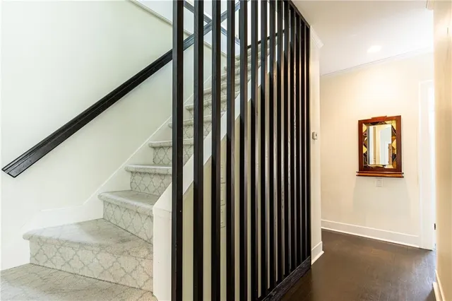 a view of staircase with railing and white walls