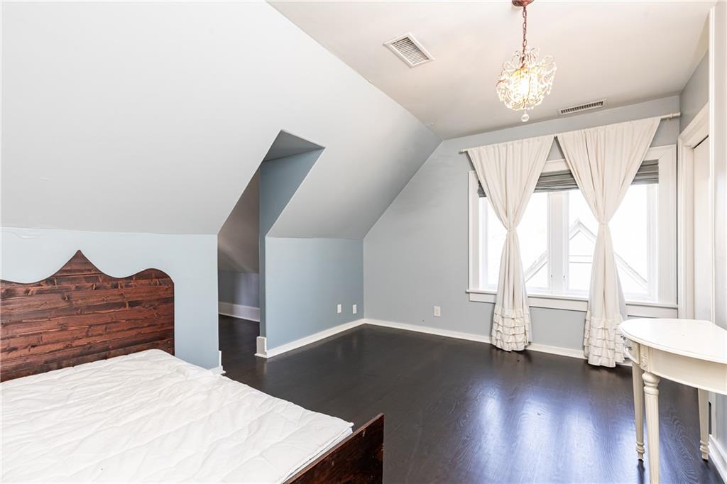 1022 Reeder Circle Northeast Atlanta, GA 30306 - Photo 25 of 37 a bedroom with a bed and a large window with wooden floor