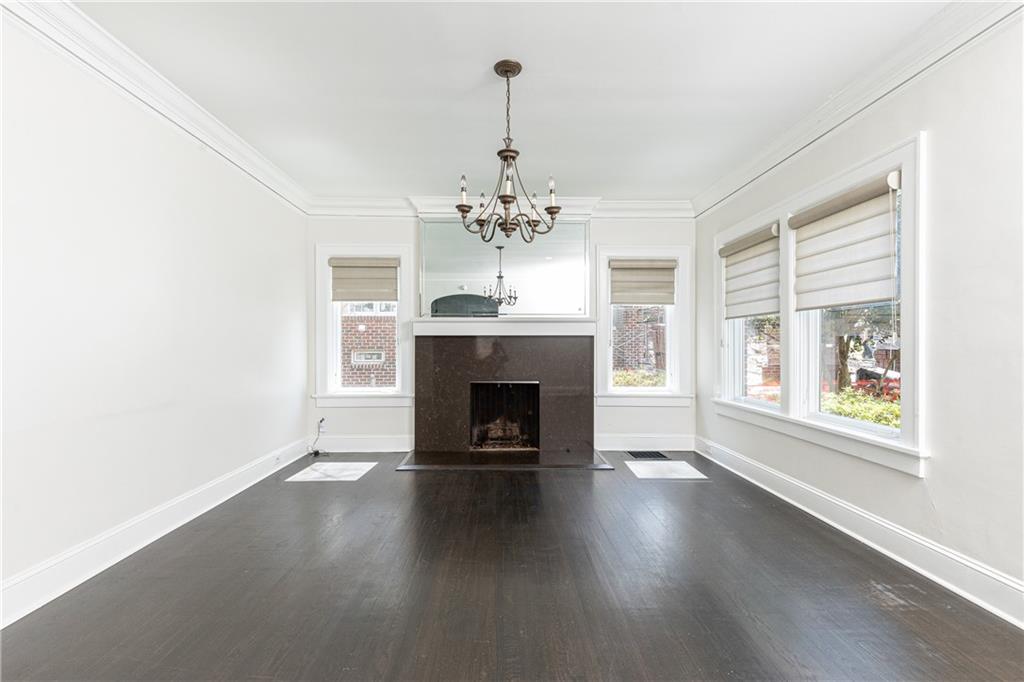 1022 Reeder Circle Northeast Atlanta, GA 30306 - Photo 3 of 37 an empty room with wooden floor fireplace and windows
