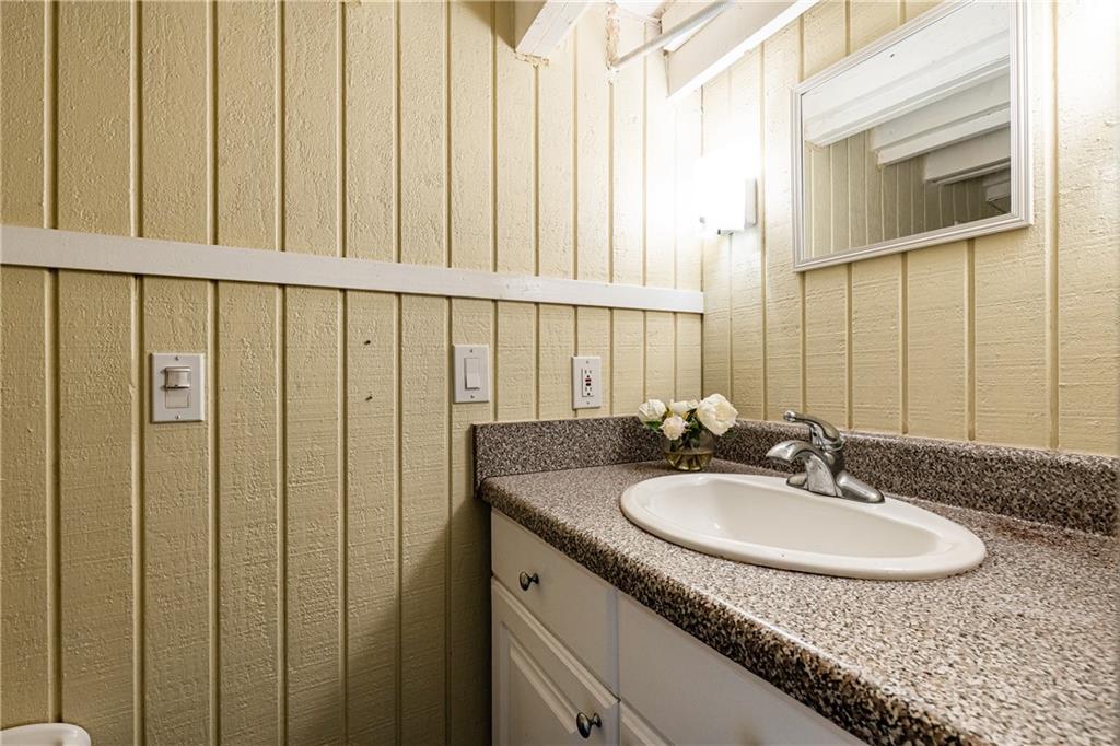 1022 Reeder Circle Northeast Atlanta, GA 30306 - Photo 33 of 37 a bathroom with a granite countertop sink and a mirror