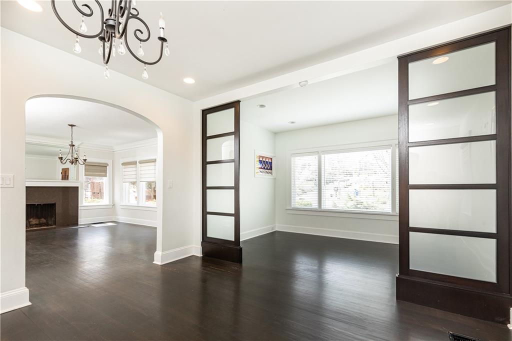 1022 Reeder Circle Northeast Atlanta, GA 30306 - Photo 6 of 37 an empty room with wooden floor and windows
