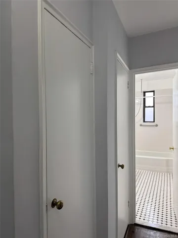 a view of a room with wooden floor and windows
