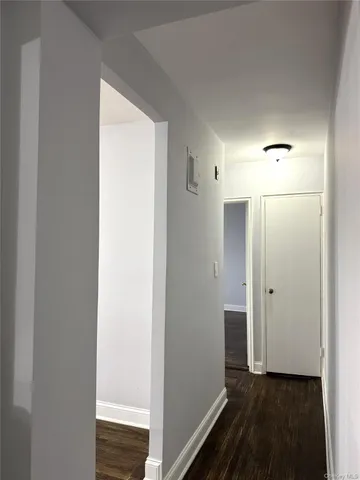 a view of hallway with wooden floor